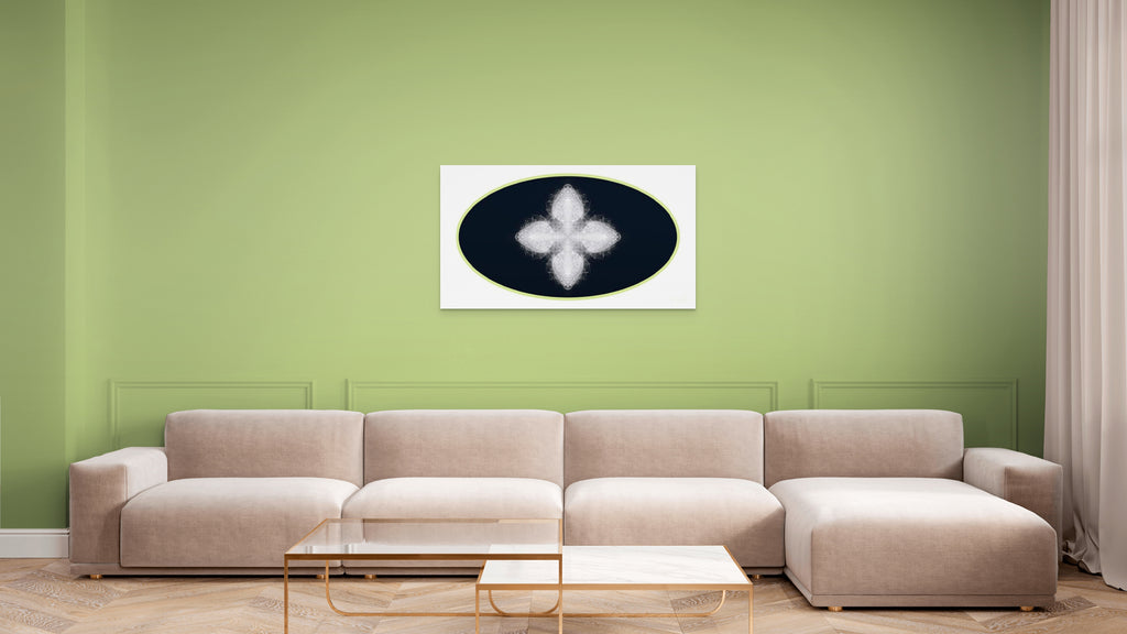 Beige sectional sofa in a living room with a green wall and geometric white, black and green artwork on wall.